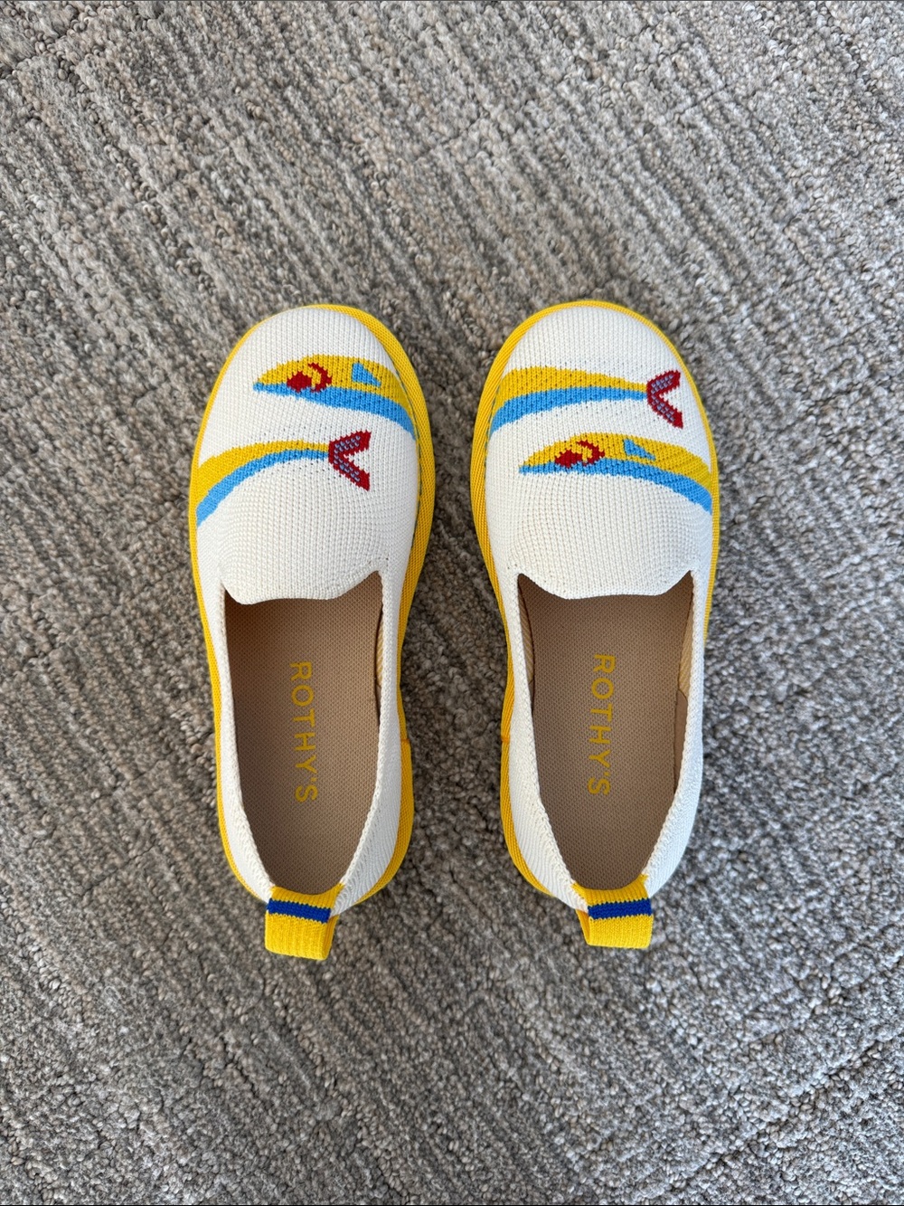 Rothy's Kids White Slip-On Shoes with Yellow Trim and Multicolor Fish